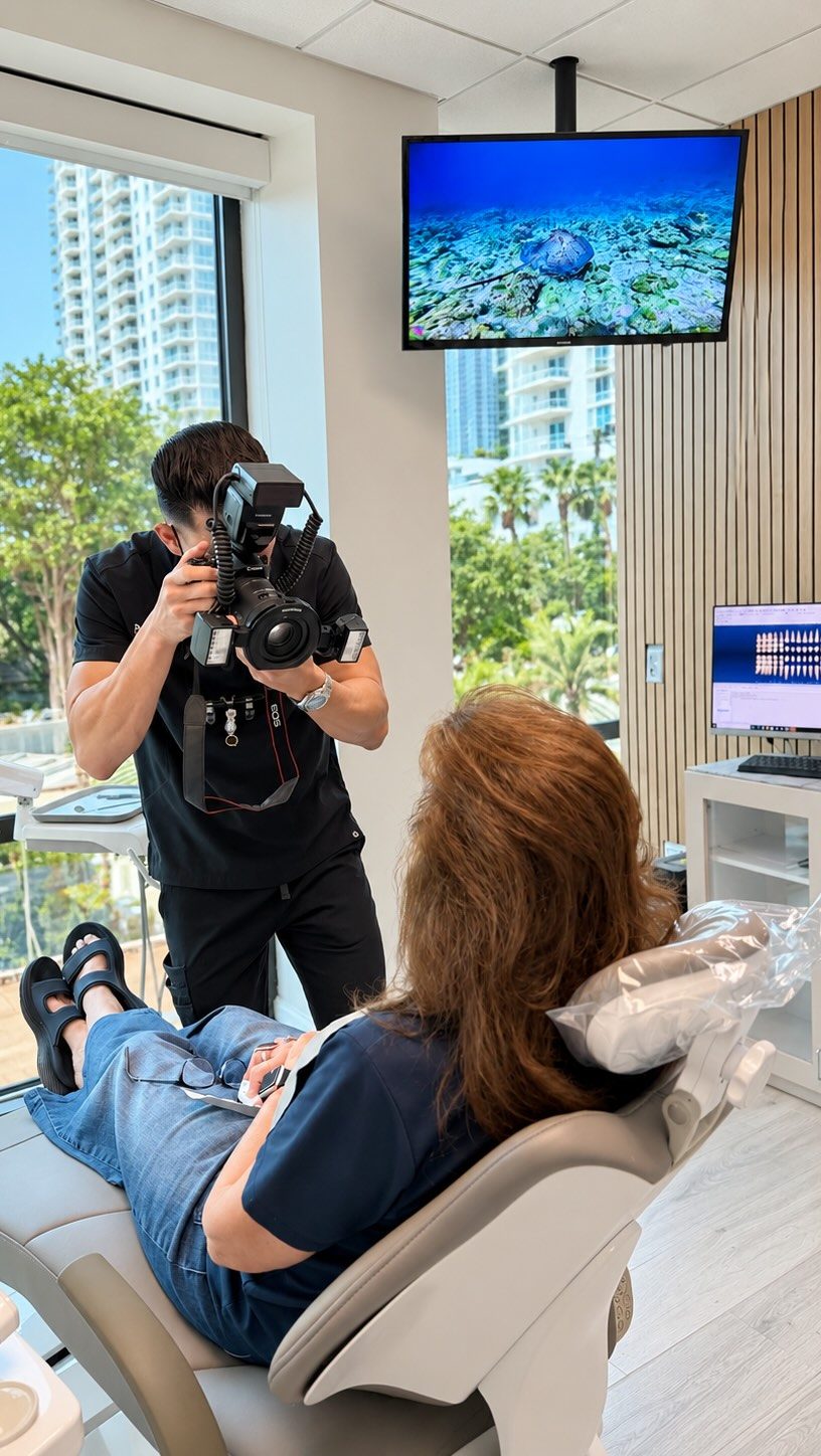 Dr. Escalante documenting a smile in the treatment room